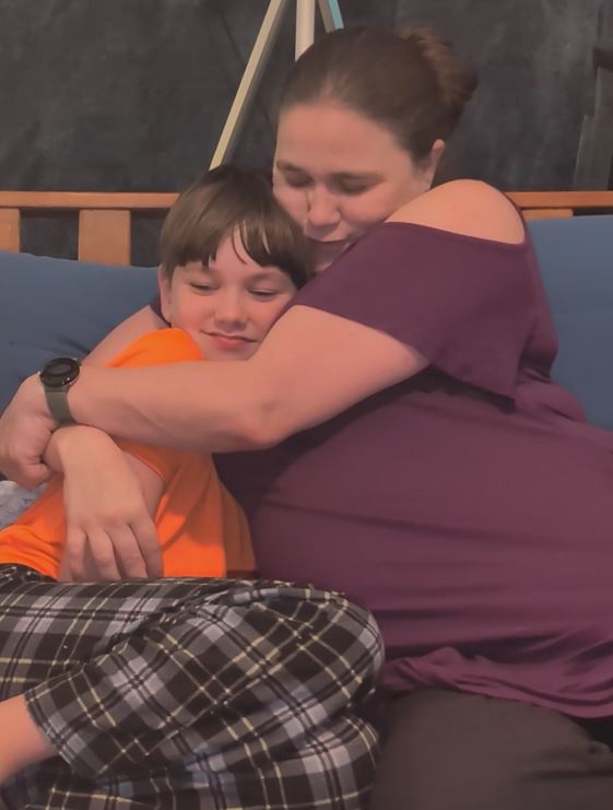 mom hugging son